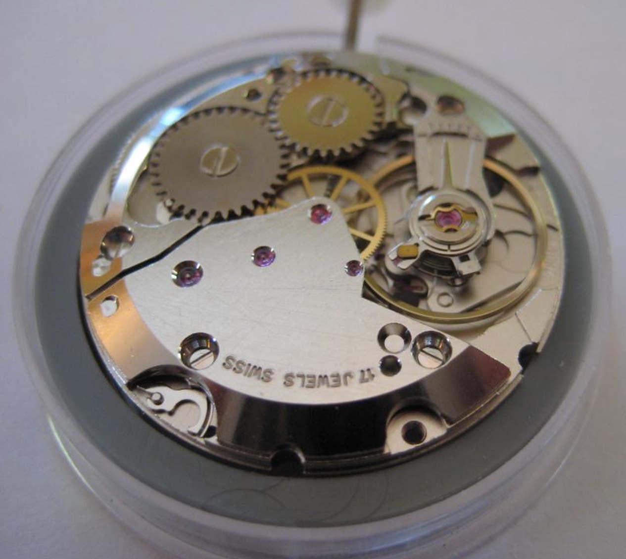 An ETA 2801 movement densely packed with metal bridges, gears, screws and red jewels